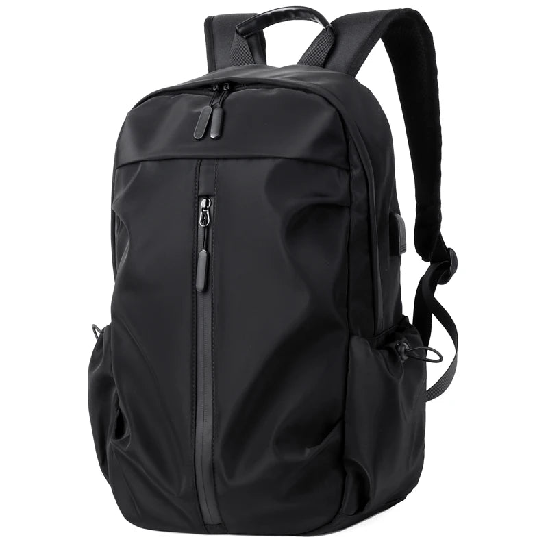Simple solid color backpack with laptop compartment and USB charging port, suitable for travel, commuting, school, business