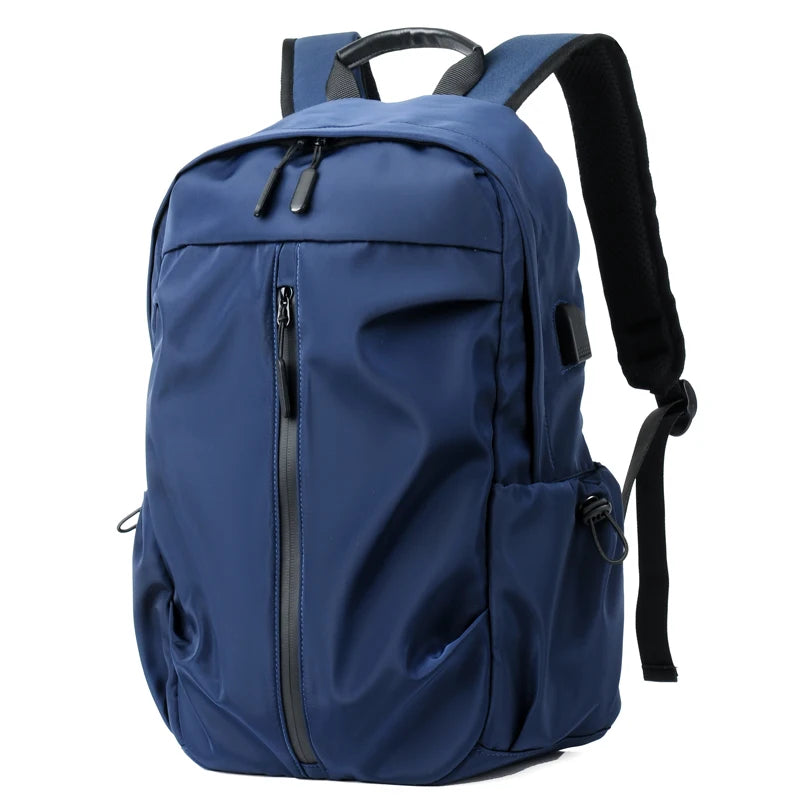 Simple solid color backpack with laptop compartment and USB charging port, suitable for travel, commuting, school, business