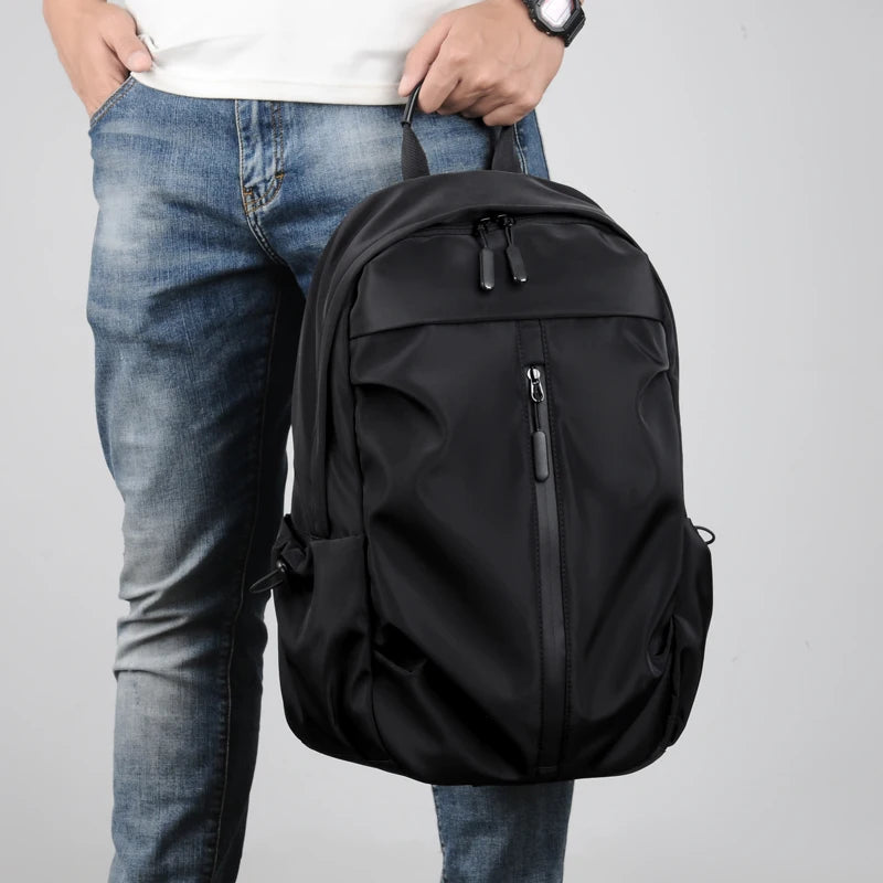Simple solid color backpack with laptop compartment and USB charging port, suitable for travel, commuting, school, business
