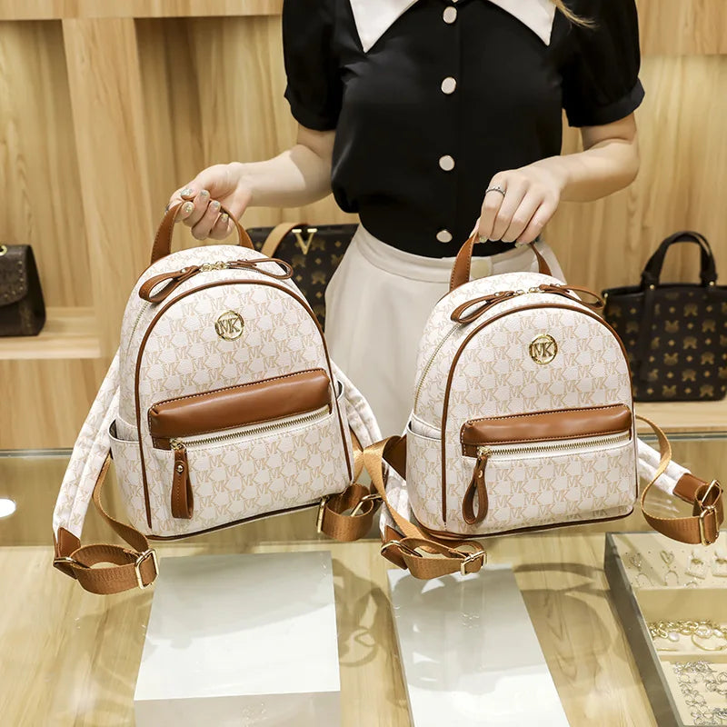 Handbag shown in clutch carry style